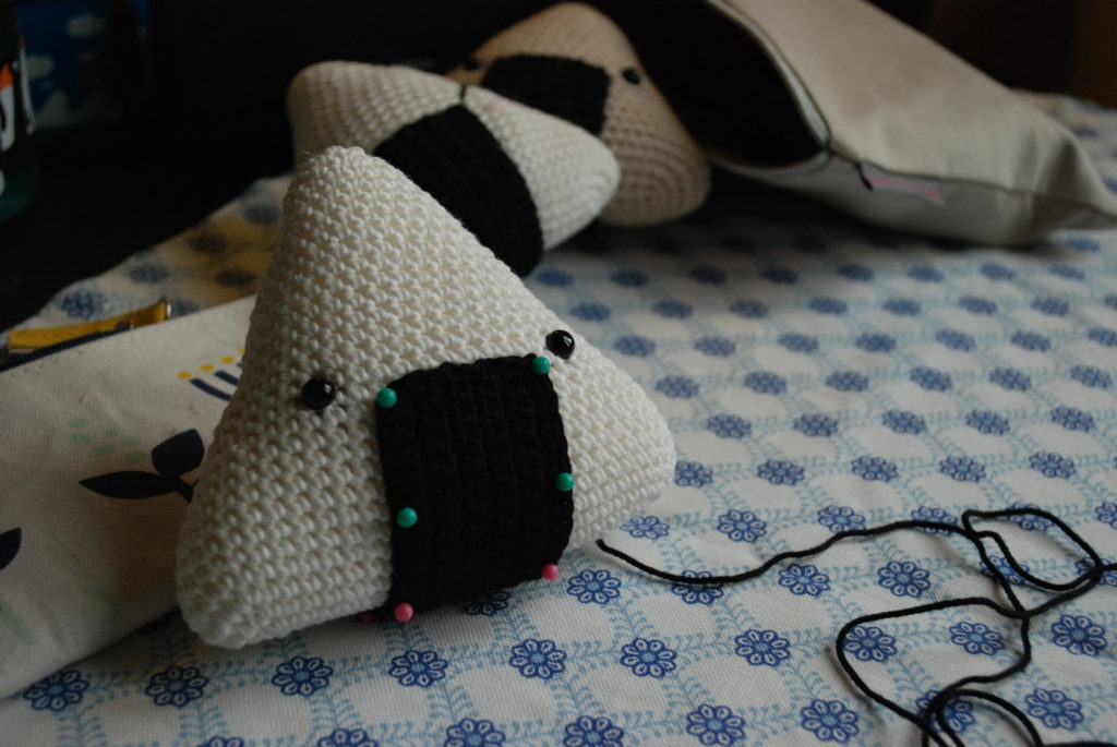 Pins on the nori of the crocheted onigiri